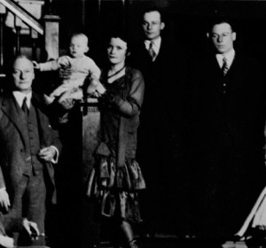 Forty-five years after the founding of the Club, first President Thomas Burgess stands at left for a family portrait in Colonel Alexander B. Crane’s entrance hall.
